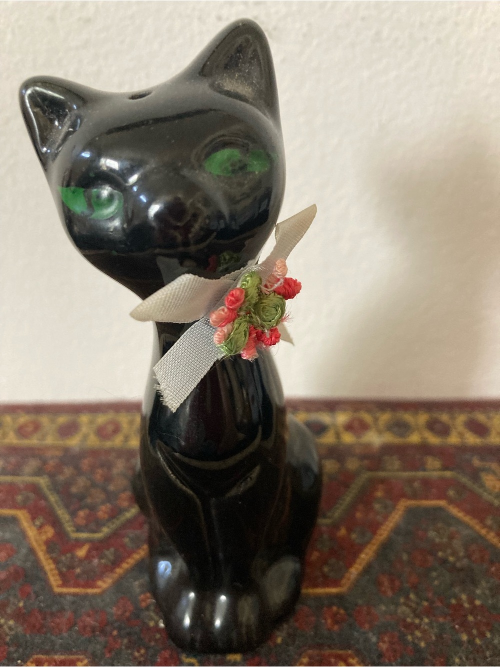 Black Ceramic Cat Figurine with Green Eyes and Decorative Ribbon